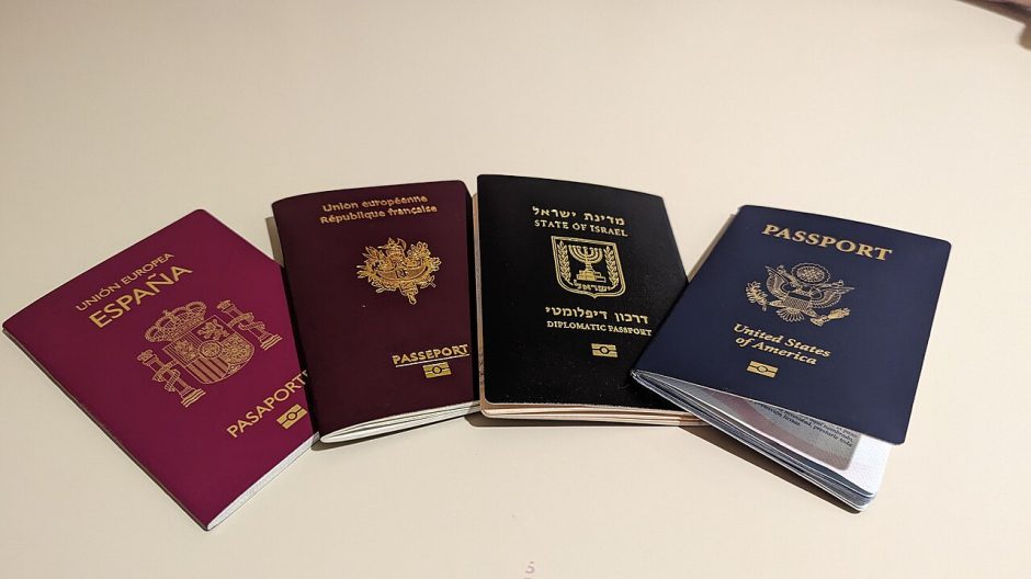 Four passports from different countries, including a U.S. passport, on a table