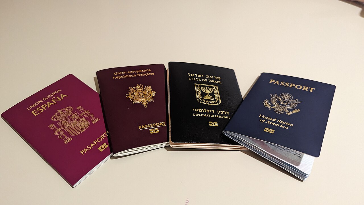 Four passports from different countries, including a U.S. passport, on a table